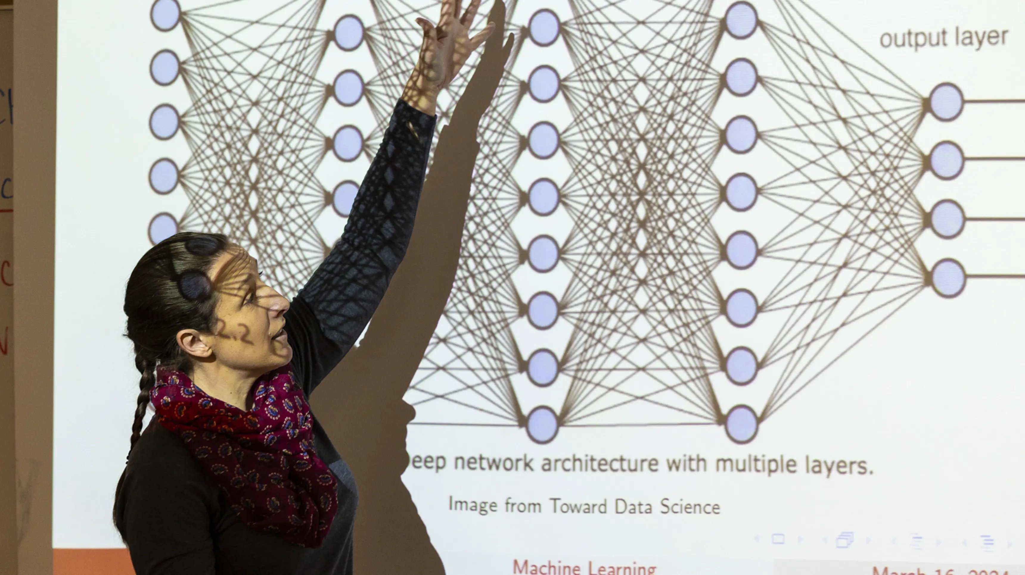 a person standing in front of a projector screen