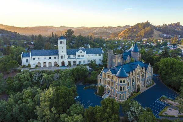 Marin campus buildings in aerial photo surrounded by green trees