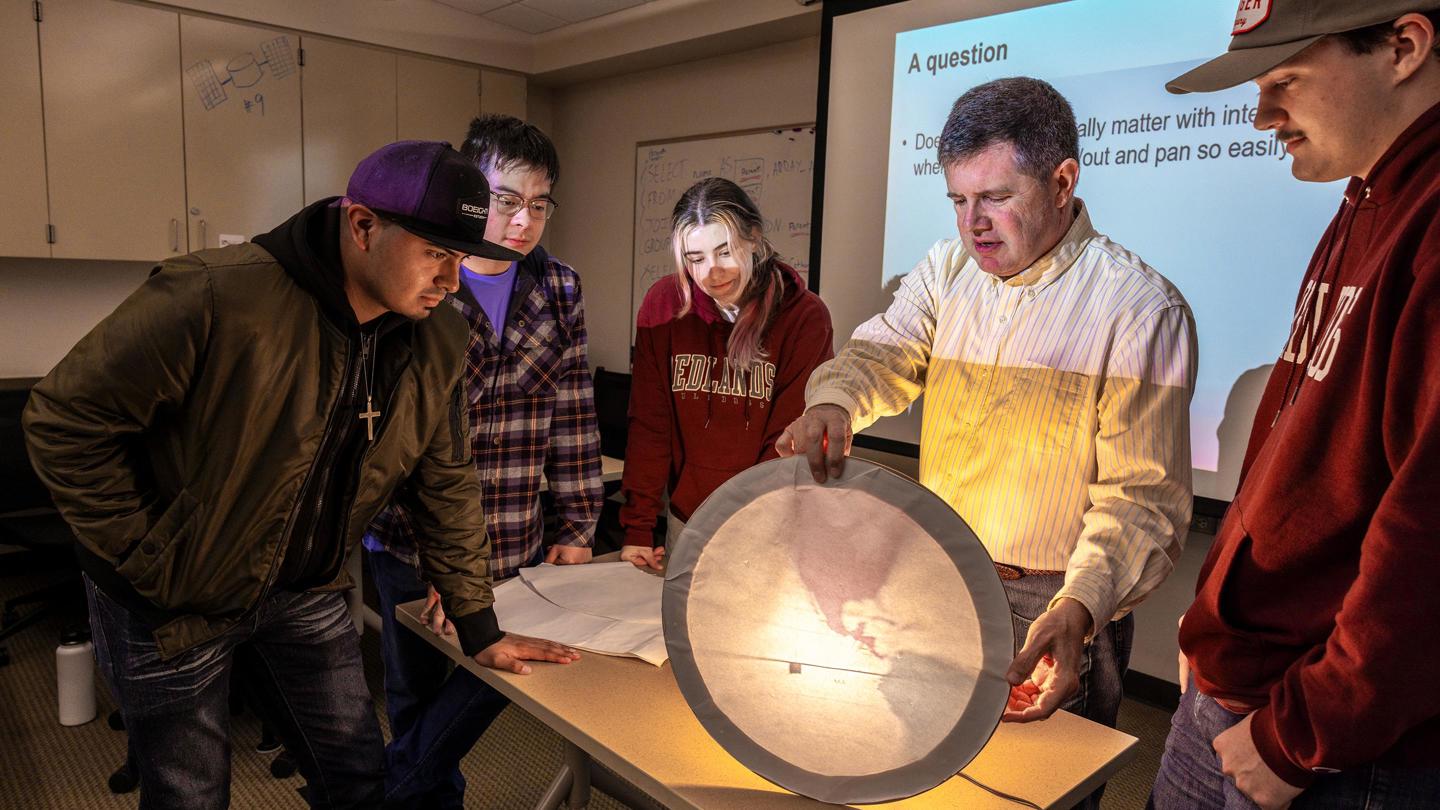 GIS professor teaching a class on light and maps.