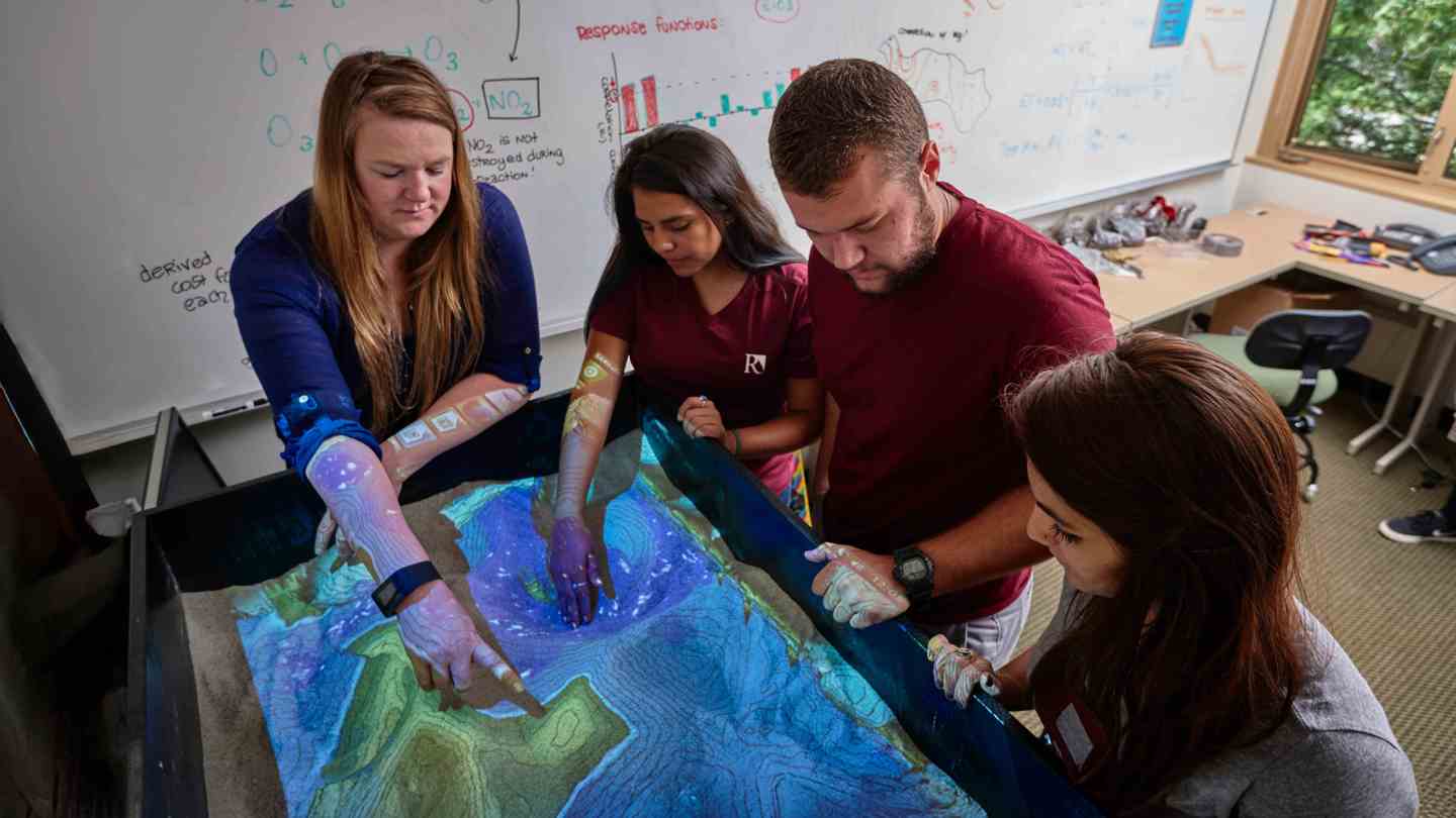 GIS students looking at map